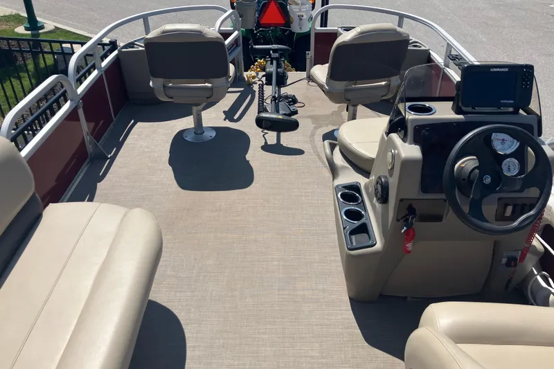 Slide: The Image of 2020 Sun Tracker Bass Buggy 18 DLX pontoon boat interior with seating and steering console. - 11