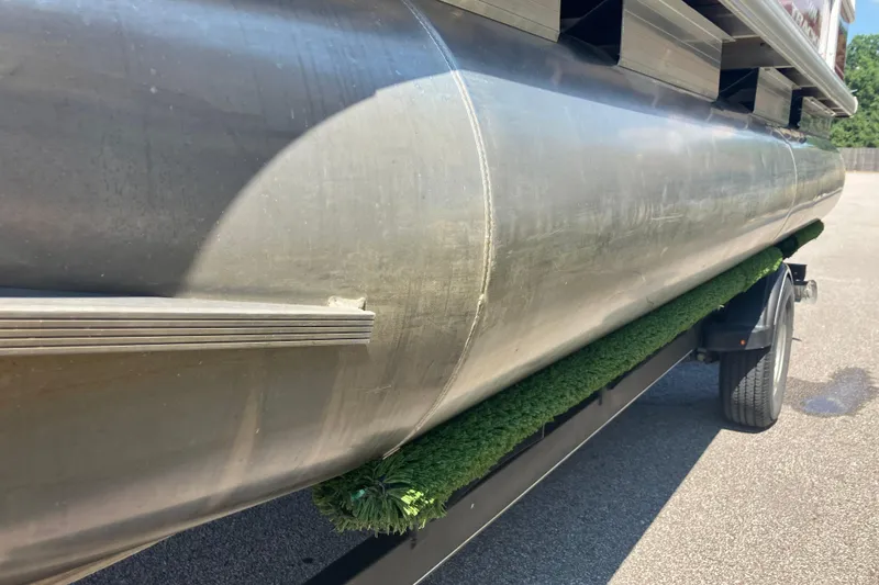 Slide: The Image of 2020 Sun Tracker Bass Buggy 18 DLX pontoon boat on trailer, close-up view. - 5