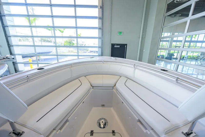 Slide: The Image of 2027 Sportsman Heritage 231 Center Console boat interior with white cushioned seating. - 13