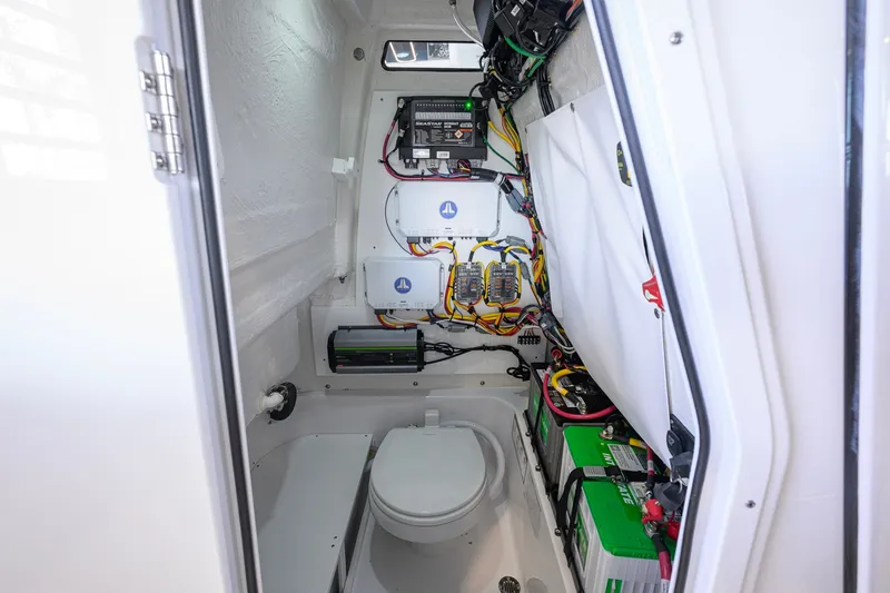 Slide: The Image of Interior of 2027 Sportsman Heritage 231 Center Console, featuring electrical components and marine toilet. - 45