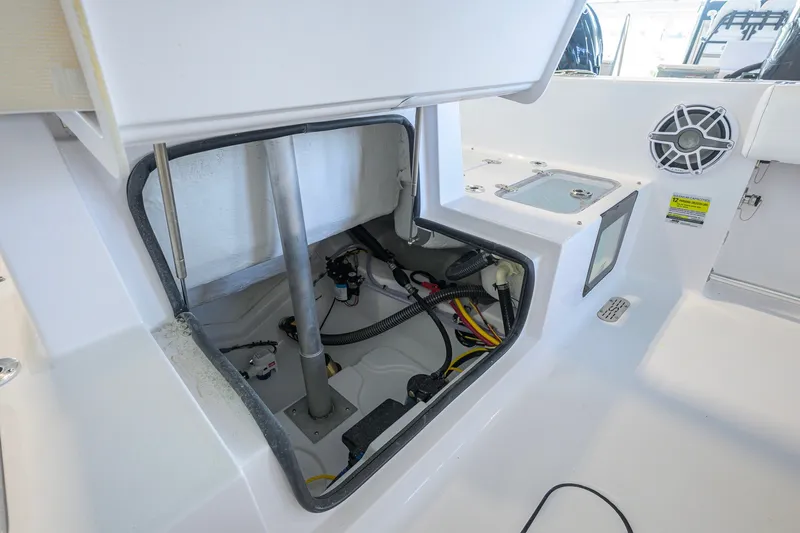 Slide: The Image of 2027 Sportsman Heritage 231 Center Console interior compartment with wiring and speaker detail. - 37