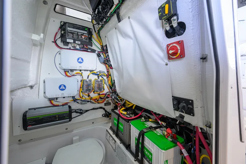 Slide: The Image of Electrical system inside 2027 Sportsman Heritage 231 Center Console boat, featuring batteries and wiring. - 47
