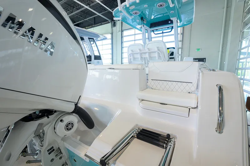 Slide: The Image of 2027 Sportsman Heritage 231 Center Console boat interior with Yamaha engine, showcasing seating and controls. - 43