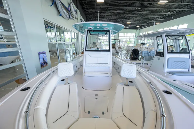Slide: The Image of 2027 Sportsman Heritage 231 Center Console boat interior in showroom setting. - 26