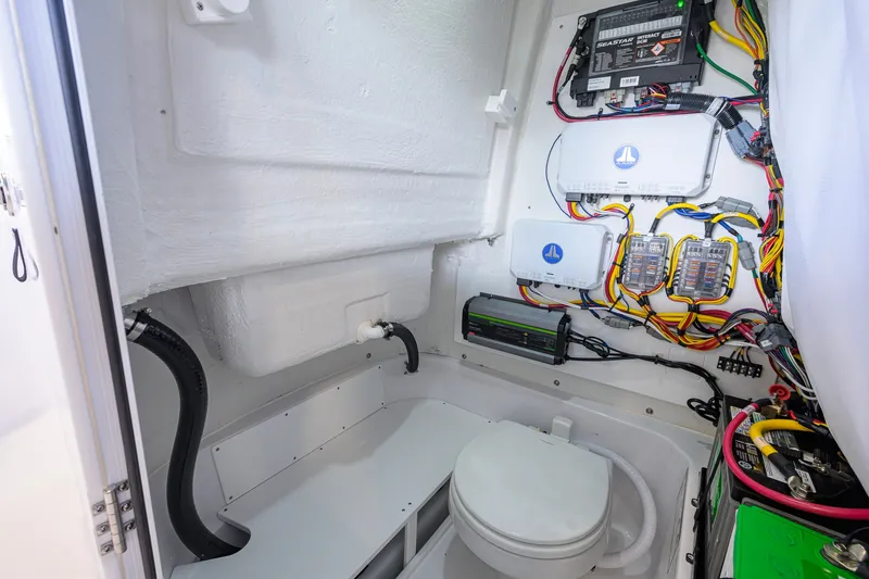 Slide: The Image of Interior of 2027 Sportsman Heritage 231 Center Console boat with wiring and marine toilet. - 46