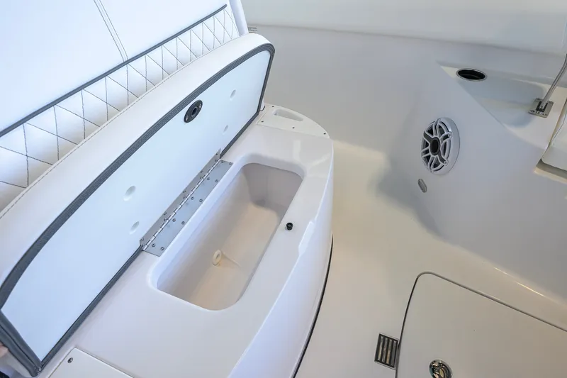 Slide: The Image of 2027 Sportsman Heritage 231 Center Console interior with storage compartment and speaker. - 22