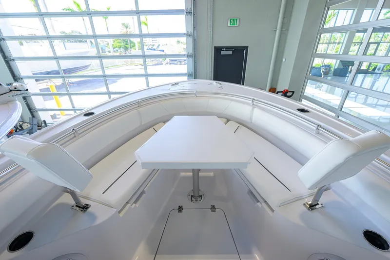 Slide: The Image of 2027 Sportsman Heritage 231 Center Console boat interior with seating and table. - 16