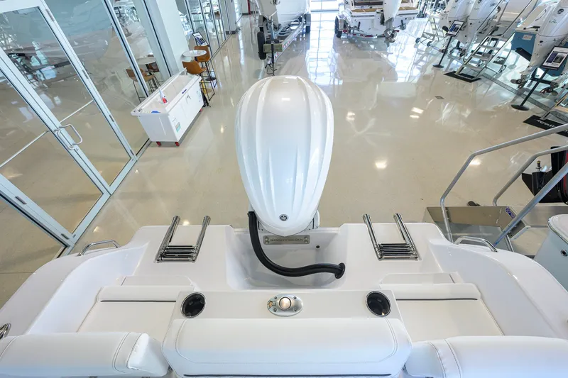 Slide: The Image of 2027 Sportsman Heritage 231 Center Console boat interior with engine view in showroom. - 44