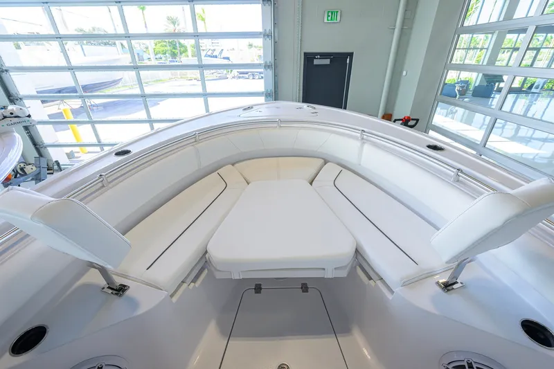Slide: The Image of 2027 Sportsman Heritage 231 Center Console boat interior with white cushioned seating. - 15