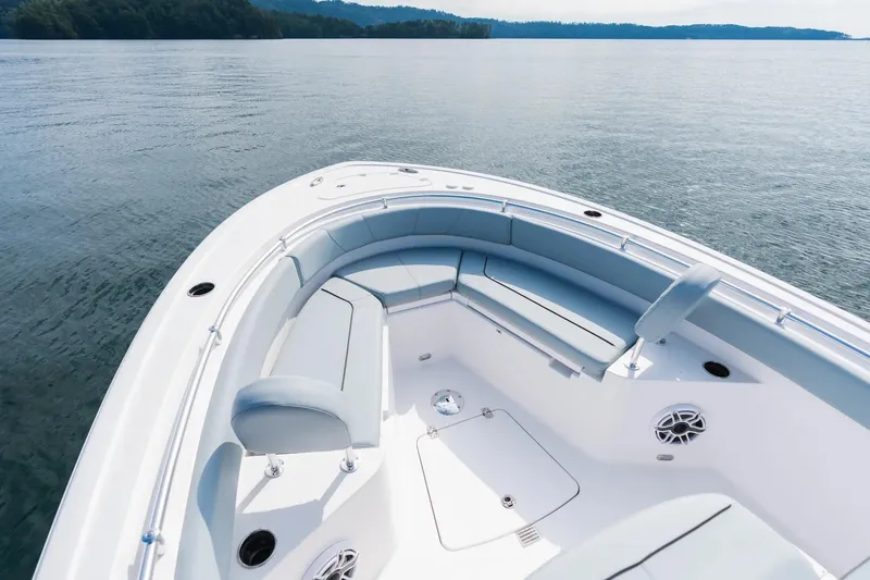 Slide: The Image of 2026 Sportsman Heritage 231 Center Console boat with spacious seating on calm water. - 2