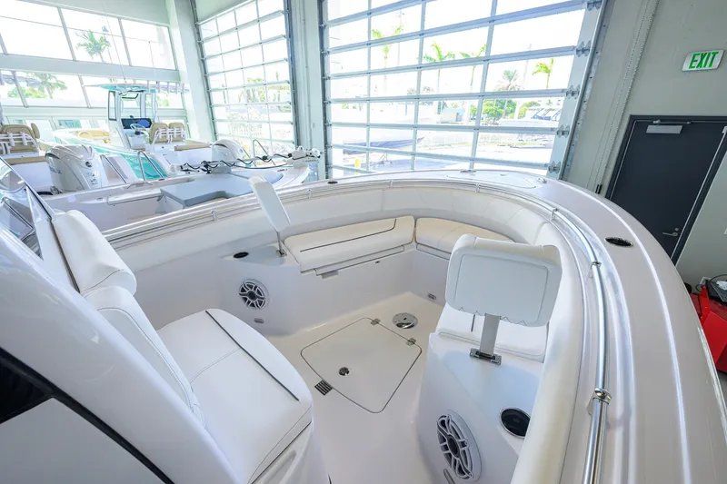 Slide: The Image of 2027 Sportsman Heritage 231 Center Console boat interior with white seating and modern design. - 19