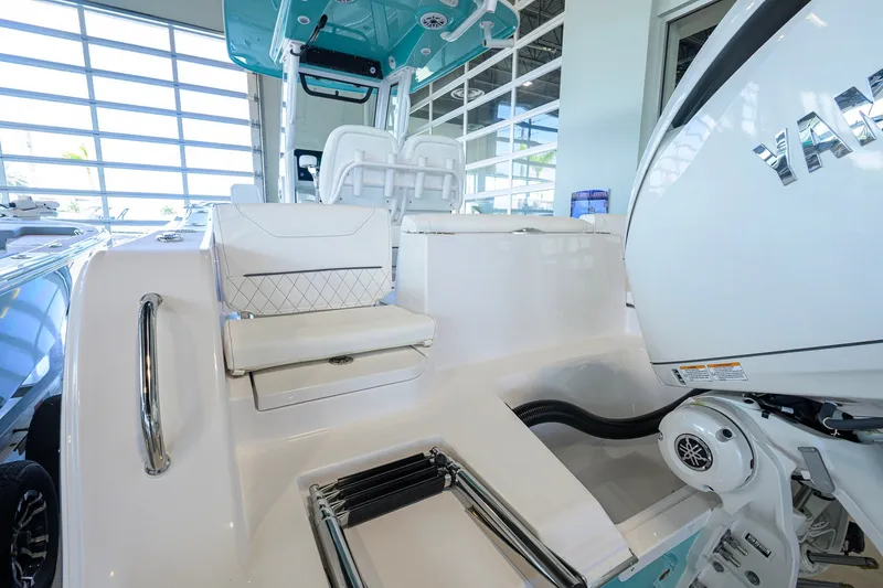 Slide: The Image of 2027 Sportsman Heritage 231 Center Console boat interior with seating and engine detail. - 42
