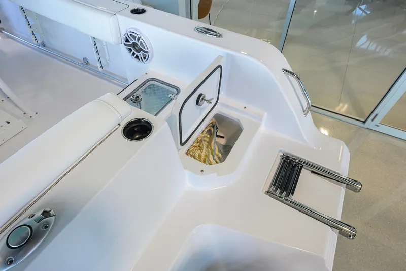 Slide: The Image of 2027 Sportsman Heritage 231 Center Console boat interior with storage compartments and ladder. - 40