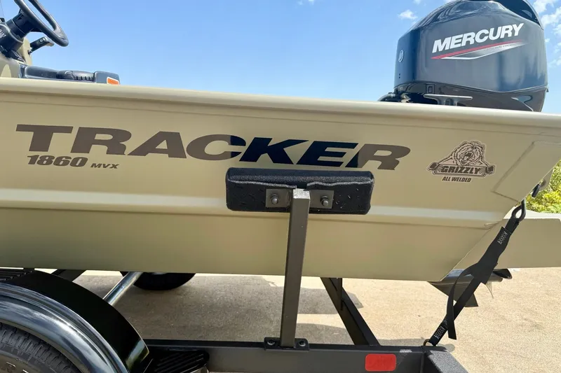 Slide: The Image of 2026 Tracker Grizzly 1860 CC boat with Mercury engine on trailer. - 13