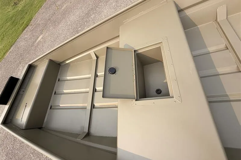 Slide: The Image of 2026 Tracker Grizzly 15 Jon boat interior with open storage compartment. - 8