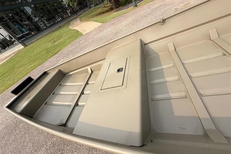 Slide: The Image of 2026 Tracker Grizzly 15 Jon boat, interior view, showcasing spacious design and storage compartment. - 7