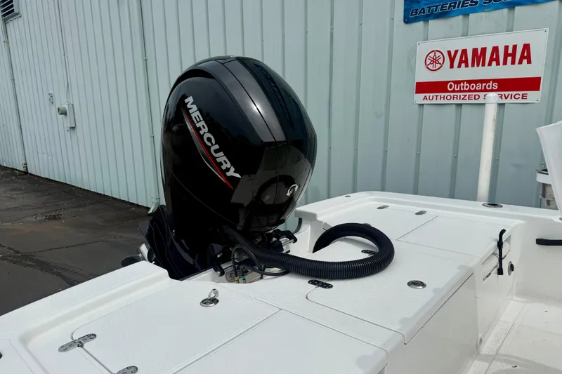 Slide: The Image of Mercury outboard motor on 2023 Frontier 2104 boat near Yamaha service sign. - 6
