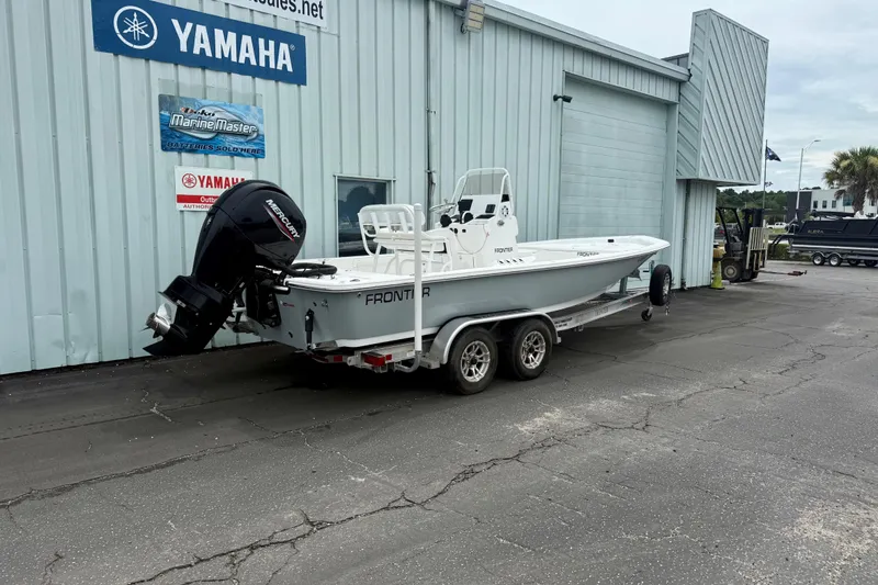 Slide: The Image of 2023 Frontier 2104 boat on trailer outside Yamaha dealership. - 2