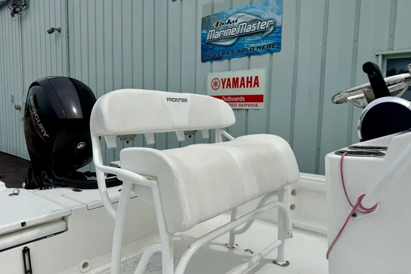 Slide: The Image of 2023 Frontier 2104 boat with Mercury engine and Yamaha service sign in background. - 5