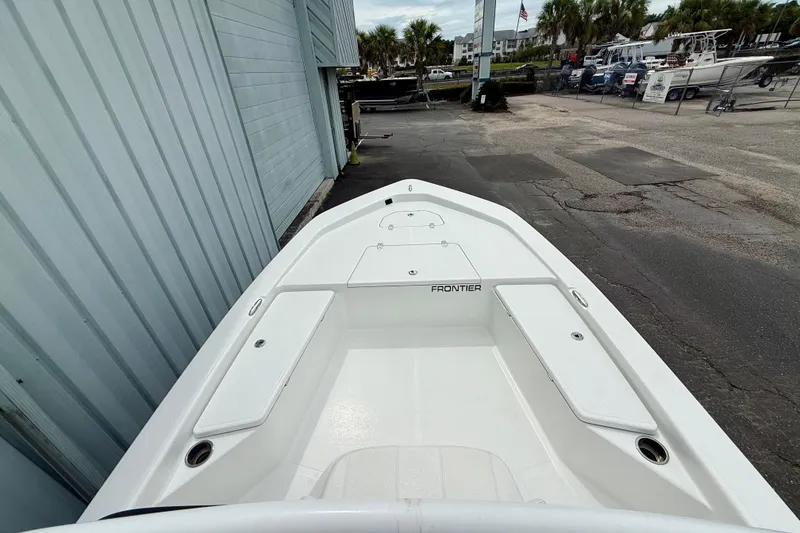 Slide: The Image of 2023 Frontier 2104 boat docked, showcasing spacious deck and sleek design. - 8