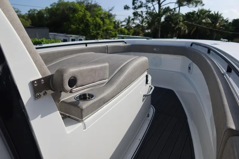 Slide: The Image of 2025 Sea Hunt Gamefish 28 Coffin Box interior with cushioned seating and cup holder. - 18