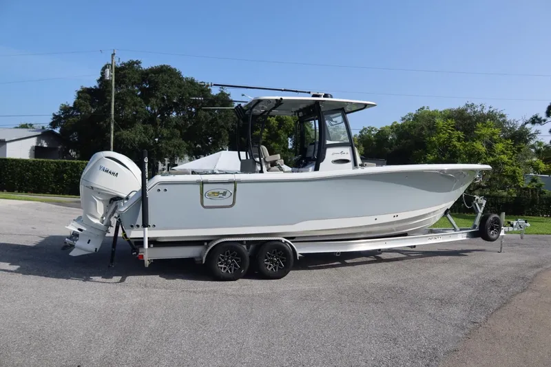 The Image of 2025 Sea Hunt Gamefish 28 Coffin Box boat on trailer, side view, outdoors. - 0