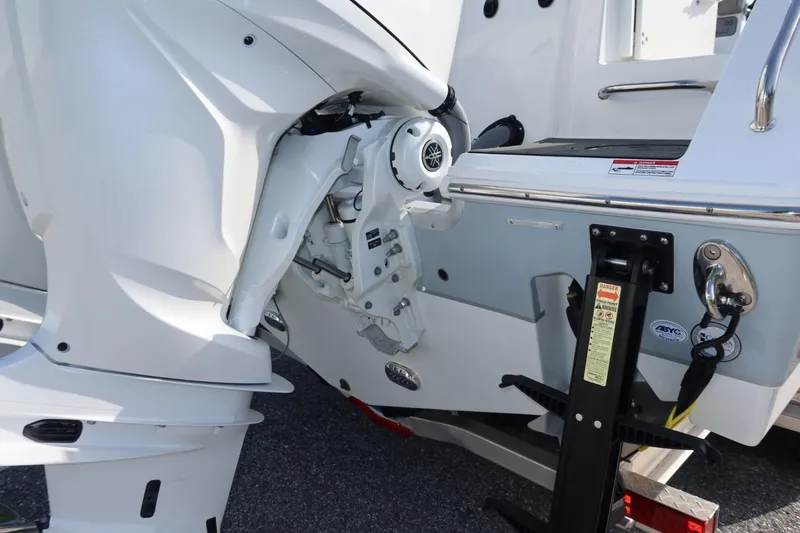 Slide: The Image of 2025 Sea Hunt Gamefish 28 Coffin Box boat engine detail, featuring sleek white design. - 13