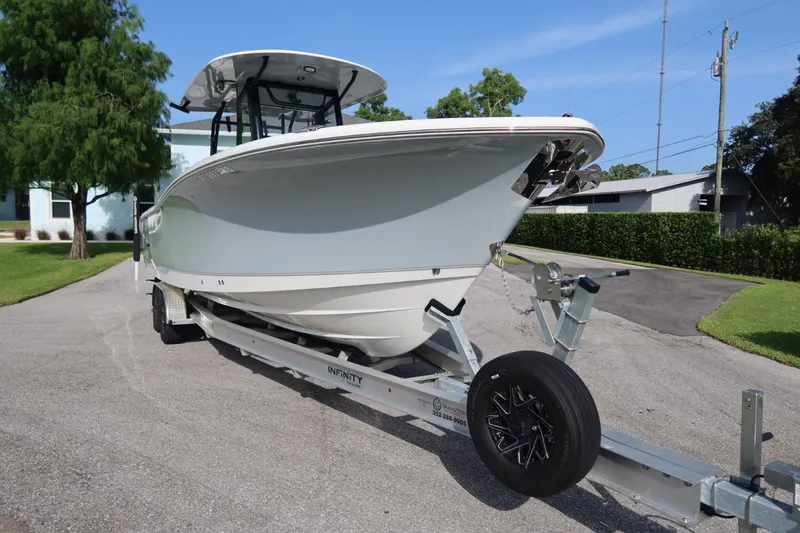 Slide: The Image of 2025 Sea Hunt Gamefish 28 Coffin Box boat on trailer, parked outdoors. - 5