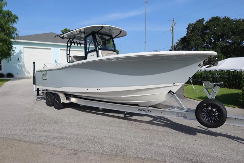 Slide: The Image of 2025 Sea Hunt Gamefish 28 Coffin Box boat on trailer, parked outdoors. - 4