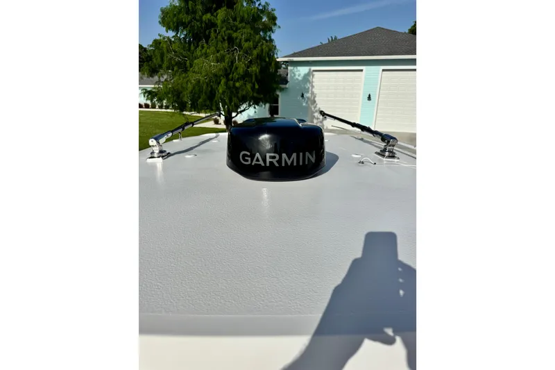 Slide: The Image of 2025 Sea Hunt Gamefish 28 Coffin Box with Garmin radar, parked near garages. - 36