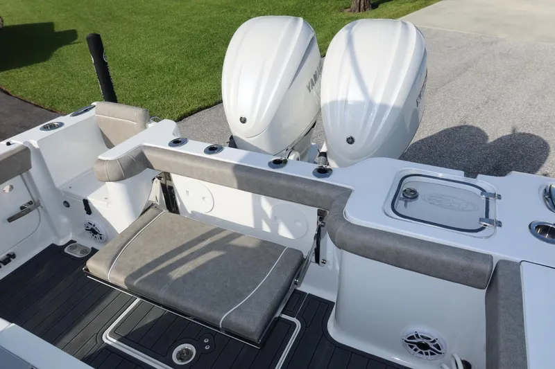 Slide: The Image of 2025 Sea Hunt Gamefish 28 Coffin Box boat with dual engines and cushioned seating. - 29