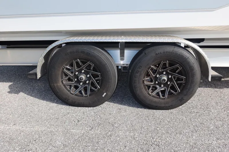 Slide: The Image of Trailer wheels of a 2025 Sea Hunt Gamefish 28 Coffin Box on asphalt. - 39