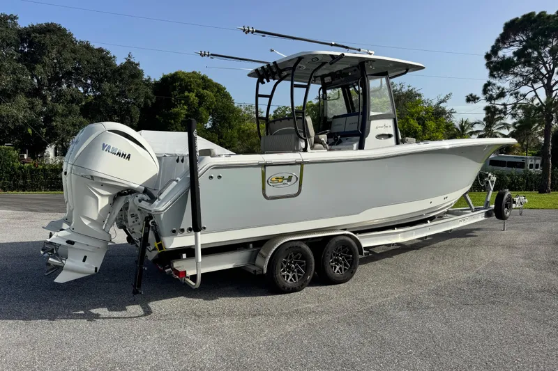 Slide: The Image of 2025 Sea Hunt Gamefish 28 Coffin Box boat on trailer, featuring Yamaha outboard motor. - 38