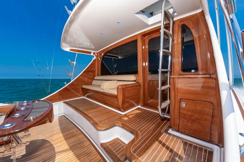 Slide: The Image of Luxurious boat with sleek wood accents, comfortable seating, and blue lighting on the deck. - 43