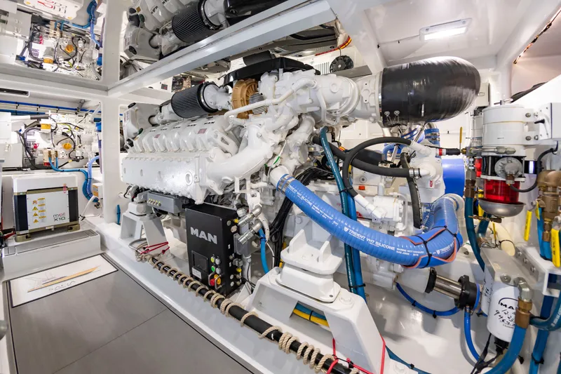 Slide: The Image of The engine room of a 2022 Scarborough 63 features powerful engines and complex piping. - 13