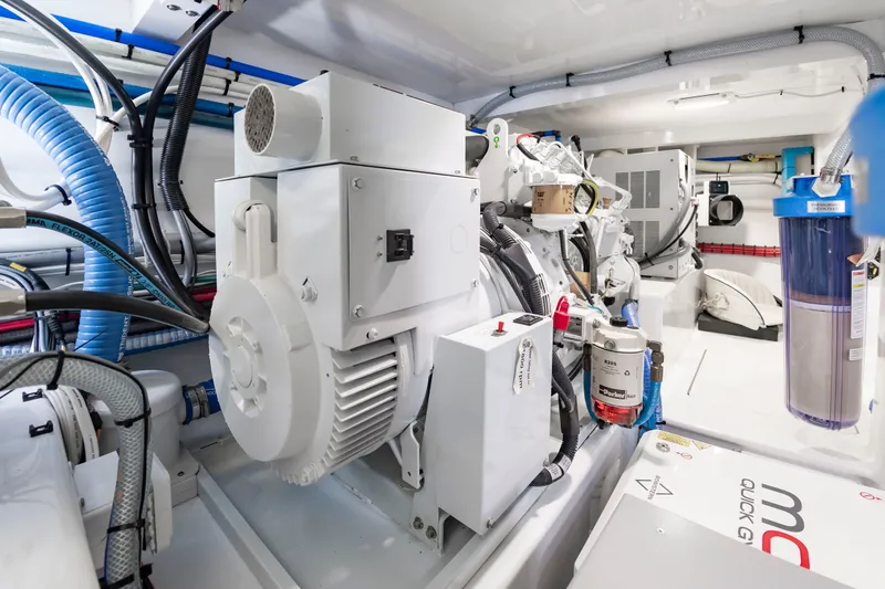 Slide: The Image of The engine room of a 2022 Scarborough 63 features modern equipment and wiring. - 22
