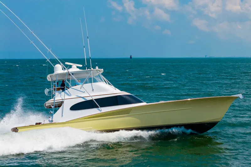 Slide: The Image of A modern Scarborough 63 boat from 2022 speeds across the sea in sunny weather. - 6