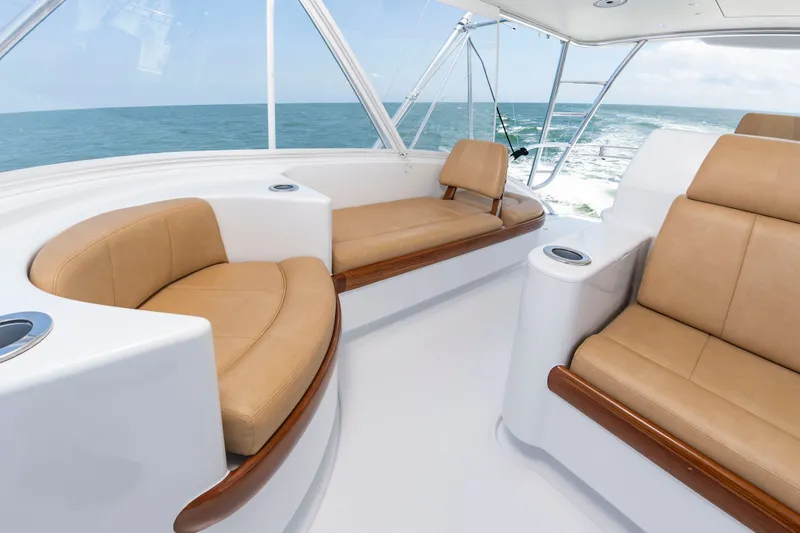 Slide: The Image of The image shows the cockpit of a 2022 Scarborough 63 with beige leather seating. - 35