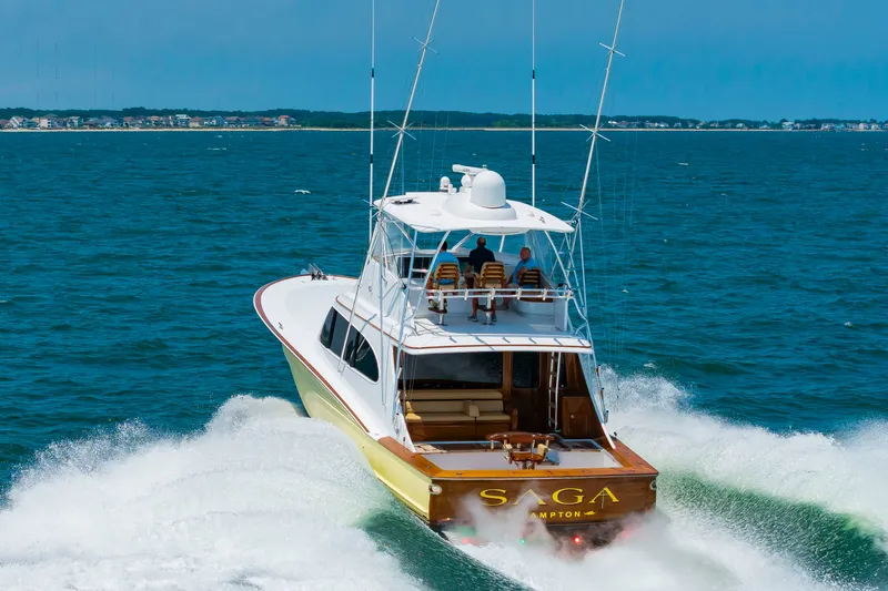 Slide: The Image of A 2022 Scarborough 63 speeds across the sea. Three people sit on the upper deck. - 2