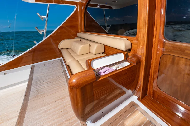 Slide: The Image of Luxurious wood interior with beige sofa on a Scarborough 63 boat, overlooking the sea. - 46