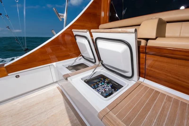 Slide: The Image of The image shows the deck of a 2022 Scarborough 63 with open coolers filled with drinks. - 47