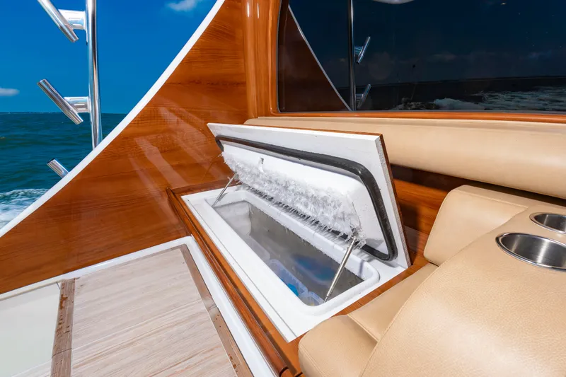 Slide: The Image of A luxurious boat cooler with ice, surrounded by polished wood and comfortable seating. - 49