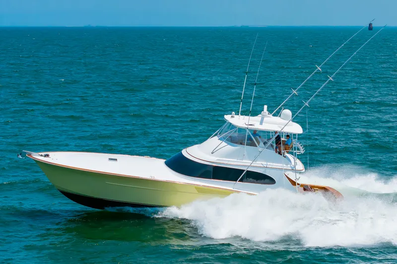 Slide: The Image of A 2022 Scarborough 63 speeds across open sea, surrounded by blue water. - 5