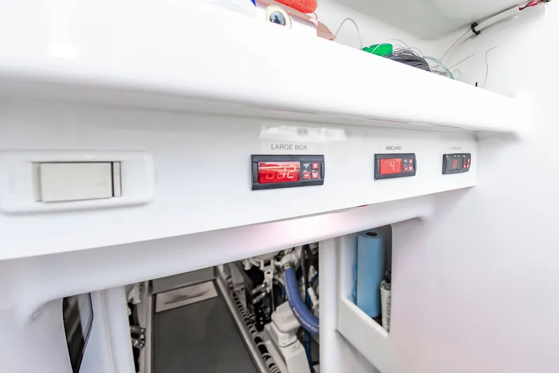 Slide: The Image of The image shows a control panel with digital displays and switches on a Scarborough 63 boat. - 28