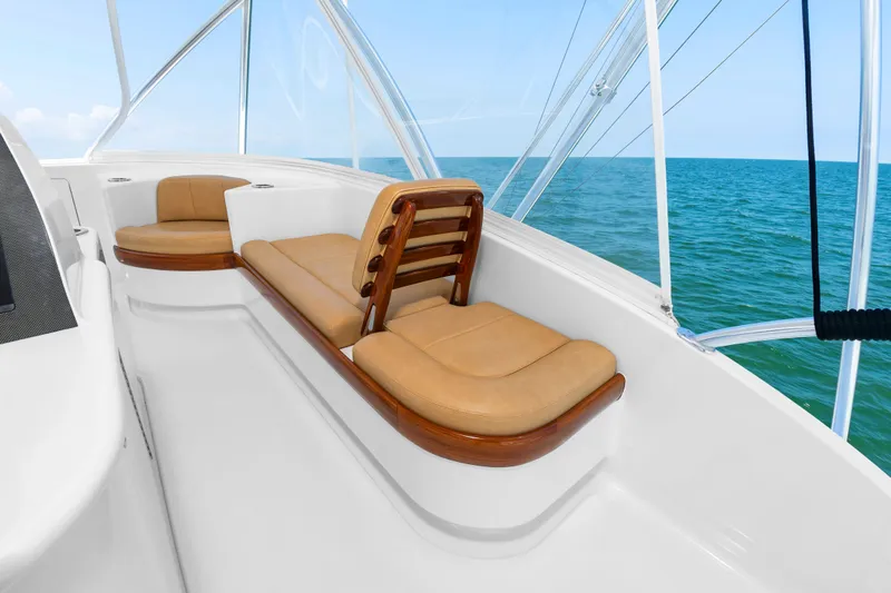 Slide: The Image of The image shows the deck of a 2022 Scarborough 63 with beige cushioned seats and a sea view. - 33