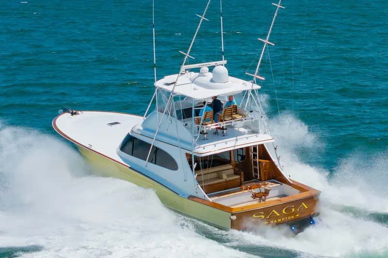 Slide: The Image of A 2022 Scarborough 63 speeds across blue water. It features a sleek design and spacious flybridge. - 8