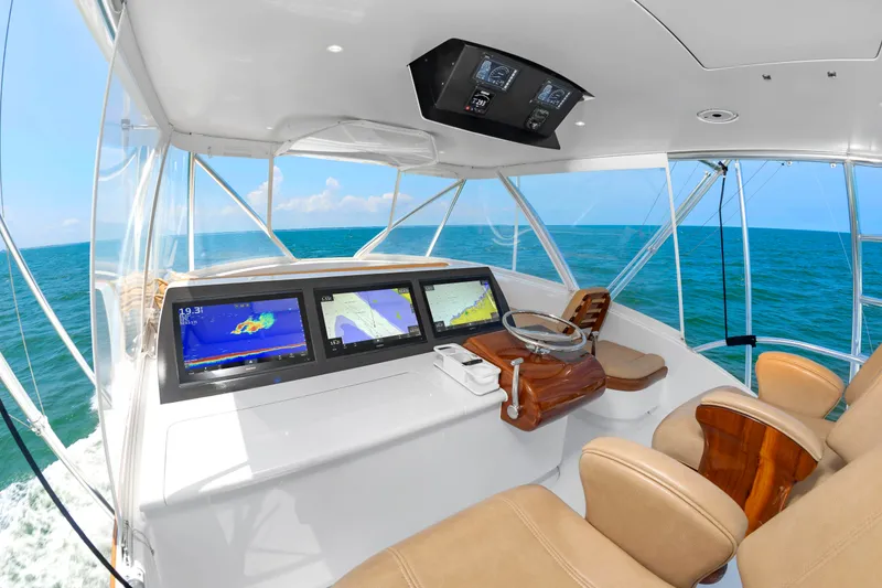 Slide: The Image of The cockpit of a 2022 Scarborough 63 with modern navigation systems and comfortable seating. - 32