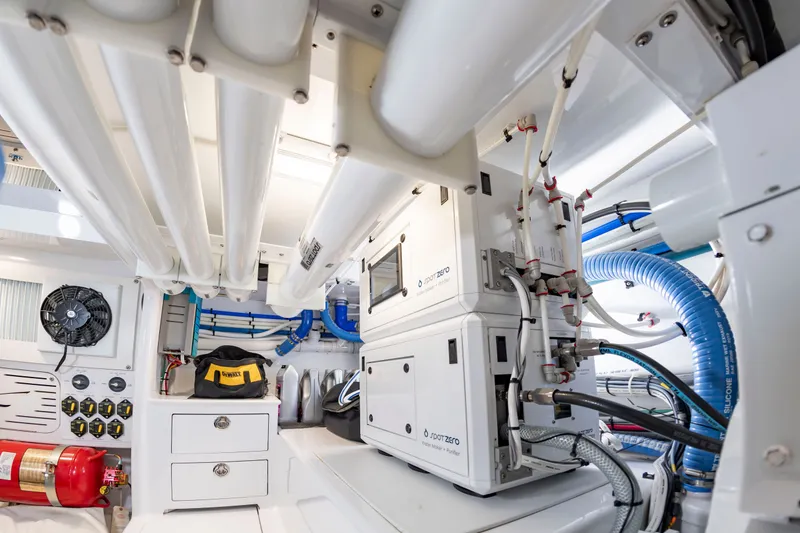 Slide: The Image of The engine room of a 2022 Scarborough 63 features modern equipment and piping. - 18