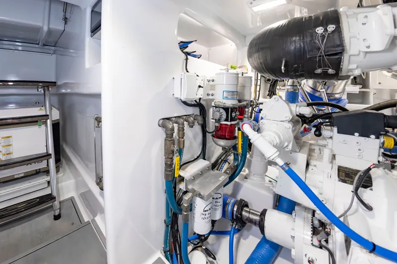Slide: The Image of The engine room of a 2022 Scarborough 63 features complex piping and technical equipment. - 17