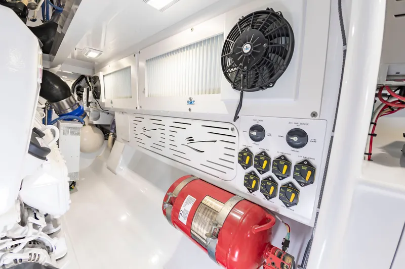 Slide: The Image of The engine room of a 2022 Scarborough 63 features fans, controls, and a fire extinguisher. - 24
